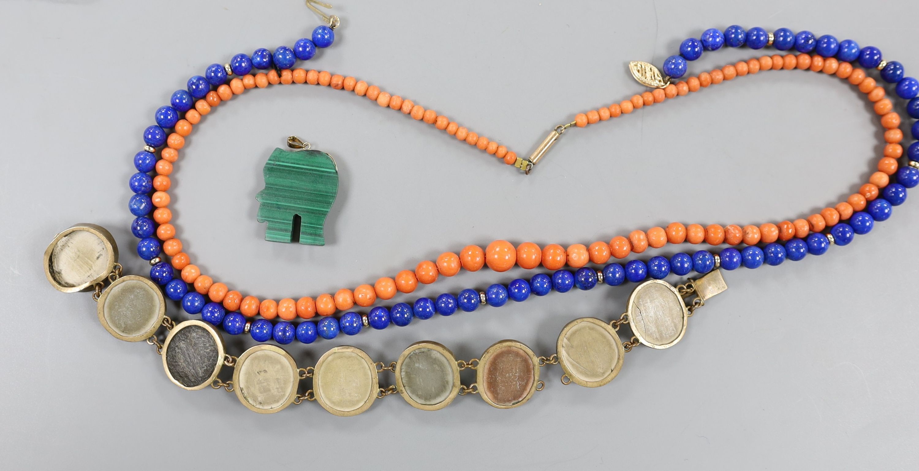 A Victorian gilt metal and lava cameo set bracelet, a 585 yellow metal mounted malachite elephant pendant and two necklaces, coral and lapis lazuli with 375 clasp.
